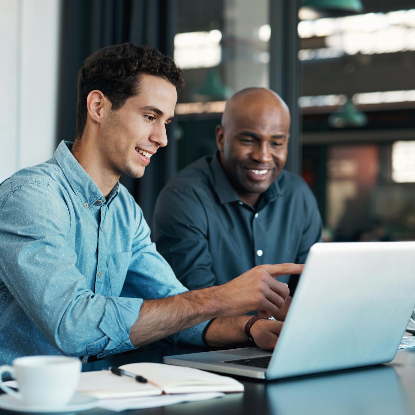 Teamwork, diversity and sales manager planning branding ideas with a creative designer on a laptop in an office. 